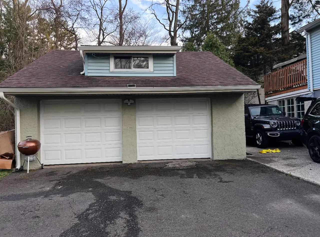 The same garage driveway cleared of the boxes, furniture, and household belongings